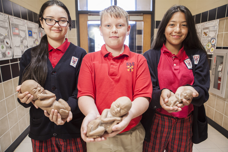 Harley, Alex, and Anahi, eighth-graders from St. Peter the Apostle Catholic School