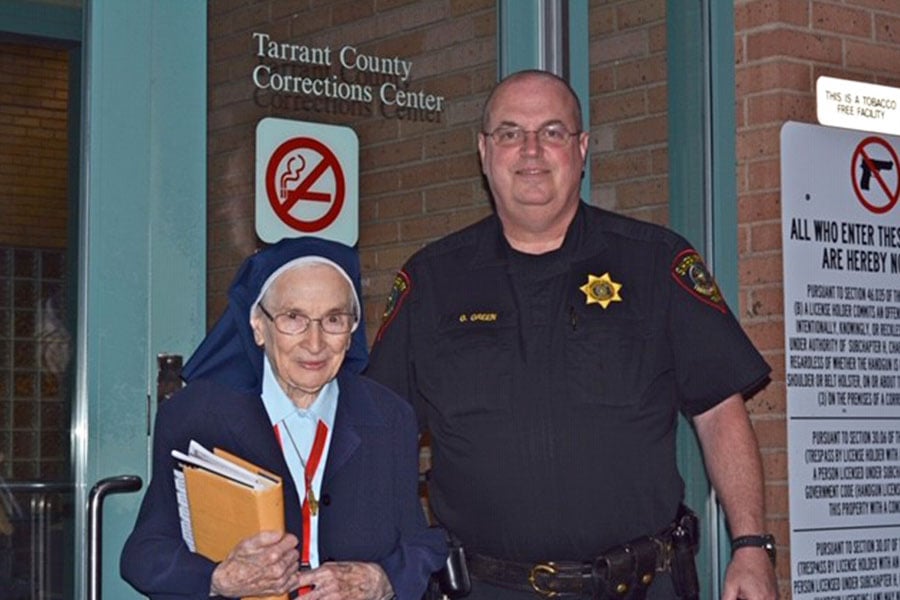 Sister Frances Vuillemin, SSMN, with Officer Green at the Tarrant County Corrections Center.