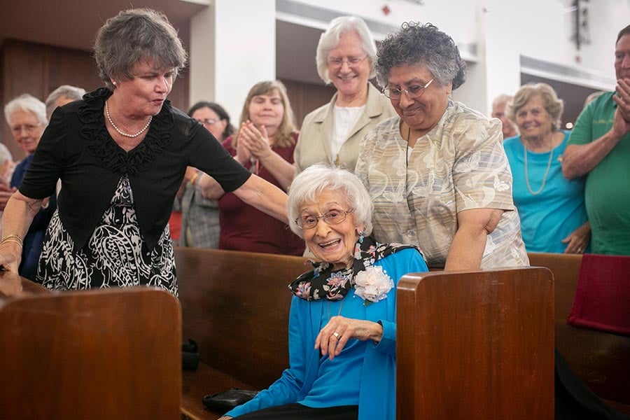 Sister Mary Frances Serafino, SSMN, is applauded by her friend and fellow sisters.