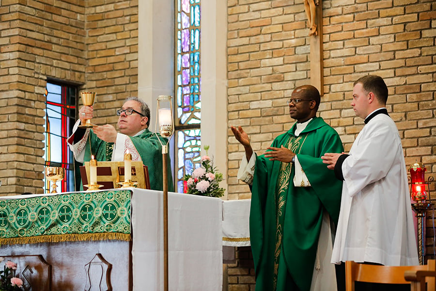 Bishop elevates chalice