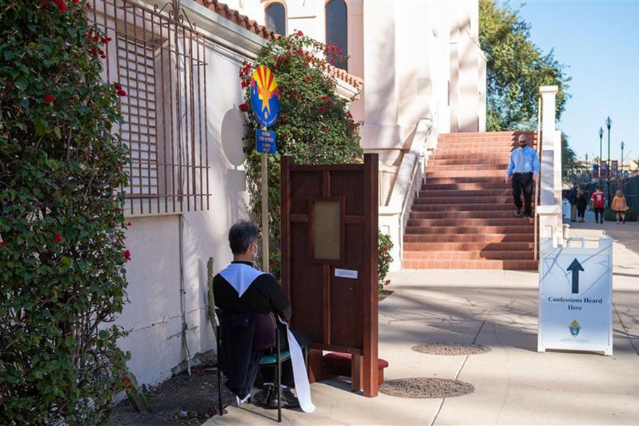 priest at outdoor confessional