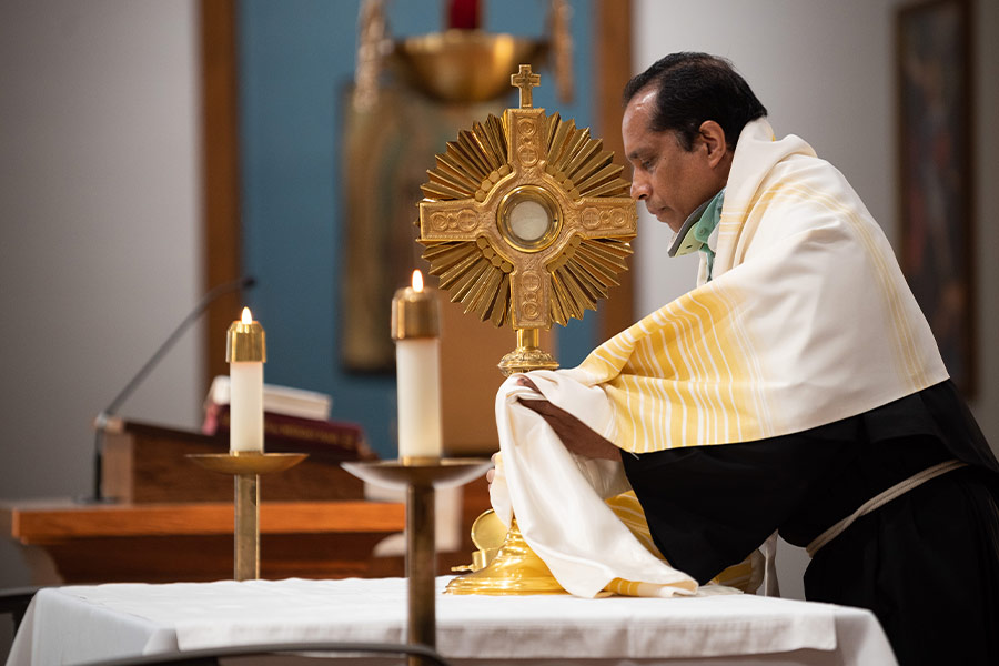 Fr. Joy Joseph prepares the Blessed Sacrament for Adoration before a parish listening session in preparation for the 2023 assembly of the Synod of Bishops, on Tuesday, March 15, 2022 at Holy Cross Parish in The Colony. Many parishes began their listening sessions with Adoration. (NTC/Ben Torres)