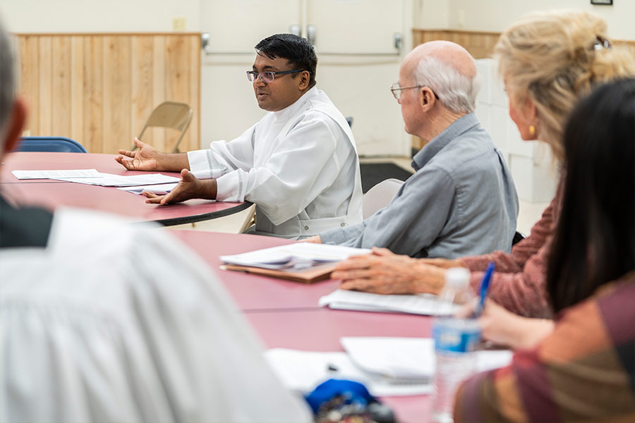 Father Prakash Dias talks with members of Sacred Heart Church in Breckenridge as they participate in a parish listening session for the 2023 synod on March 19, 2022. (NTC/Juan Guajardo)