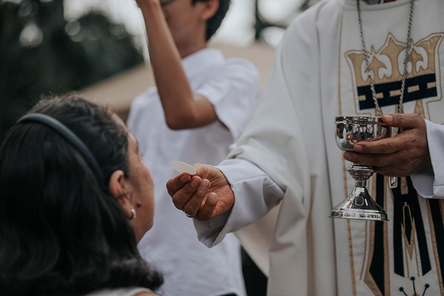girl receives Eucharist