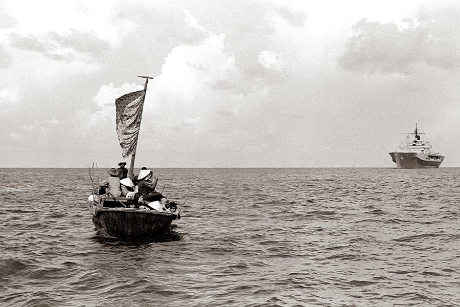 Hundreds of thousands of Vietnamese Catholics fled the country's communist regime in boats similar to the one pictured here awaiting rescue by the USS Blue Ridge in 1984. (U.S. Navy/James Franzen)