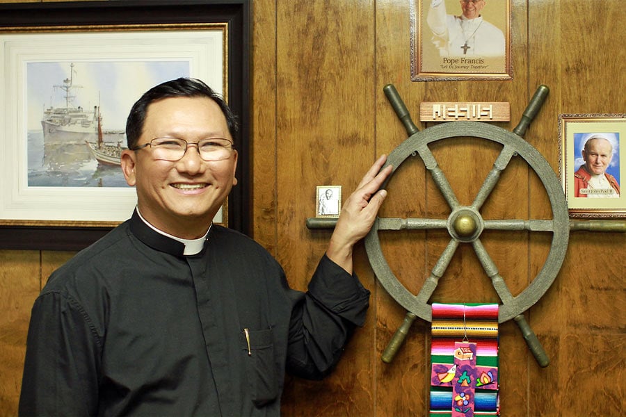 Father Hoa Nguyen took turns at the helm of a modest fishing boat that carried 43 refugees to freedom after 31 days adrift on the South China Sea. The steering wheel from the fishing boat was given to him by the ship’s captain in 2012, on Fr. Hoa’s 15 anniversary as a priest. (NTC/Jerry Circelli)