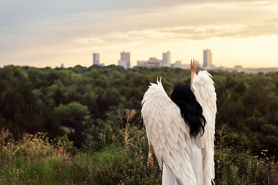 an angel looks over the skyline of the city of fort worth