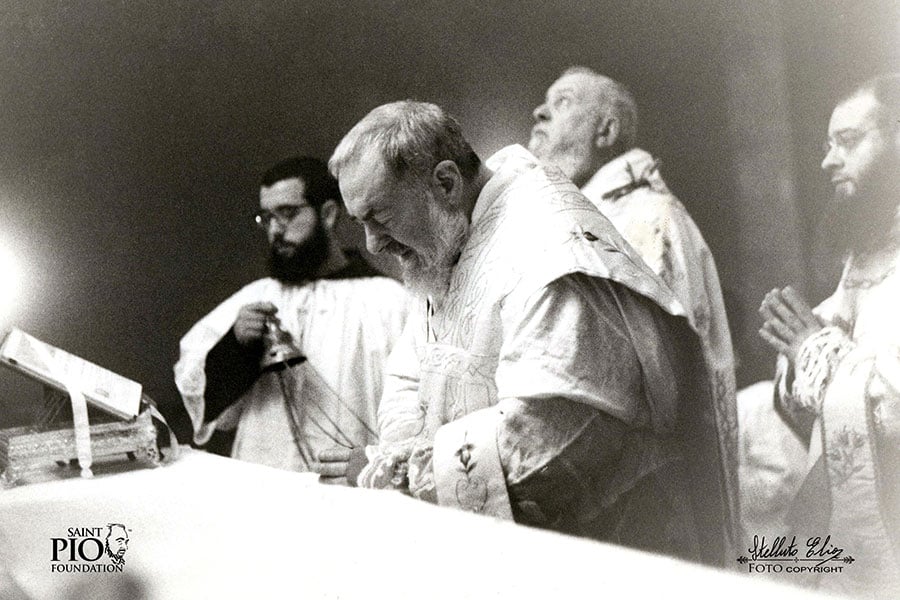Padre Pio bows before the monstrance