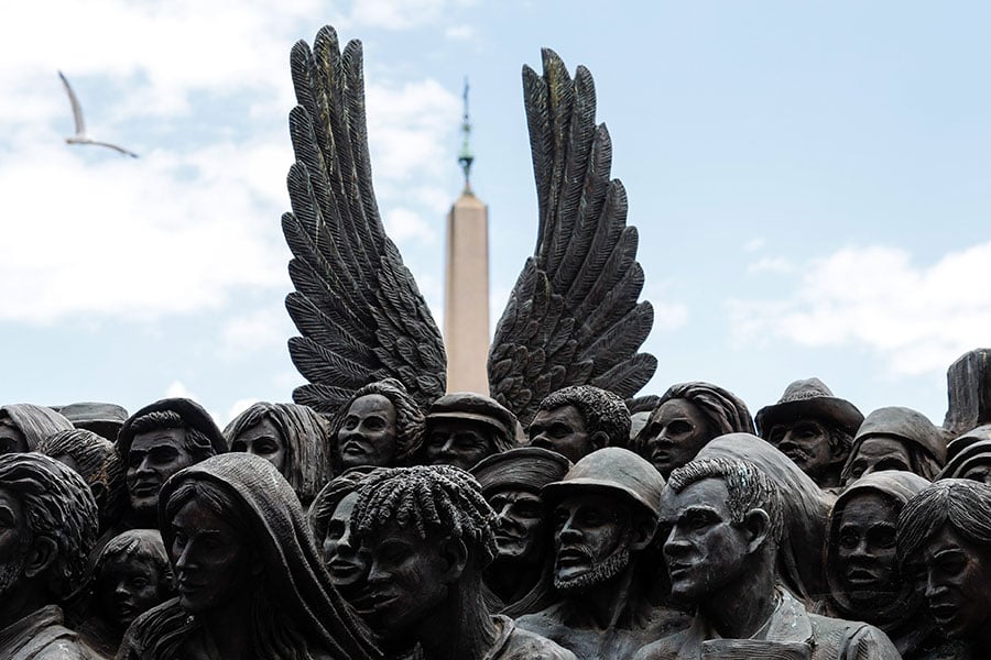 A detail shot of wings behind the migrant saints statues at the vatican