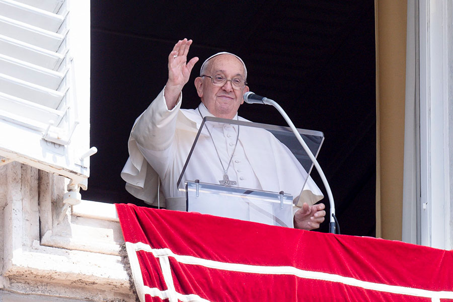 Pope Francis waves to visitors and pilgrims gathered in St. Peter's Square at the Vatican for the recitation of the Angelus prayer Aug. 15, 2024, the feast of the Assumption of Mary. (CNS photo/Vatican Media)