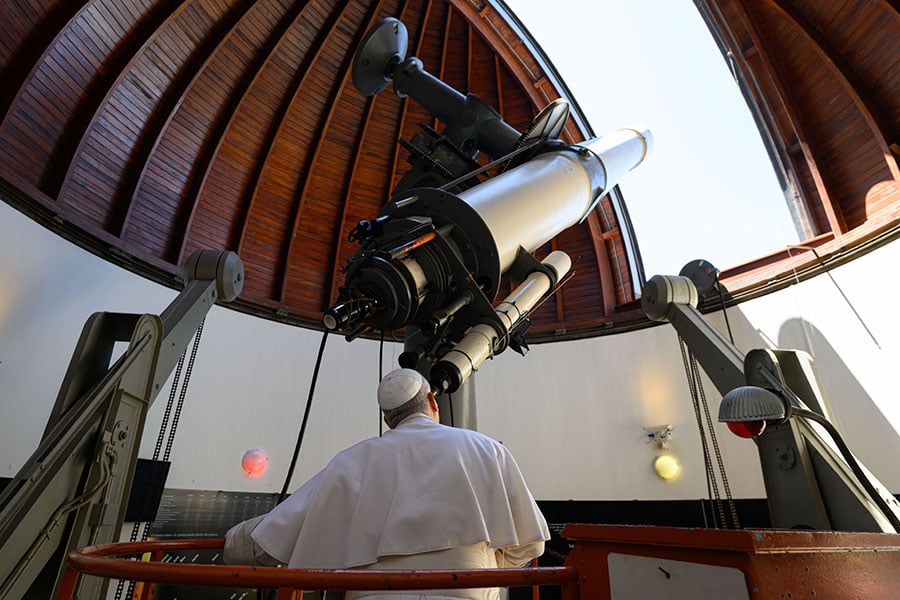 Pope Leo XIV peers through a giant telescope