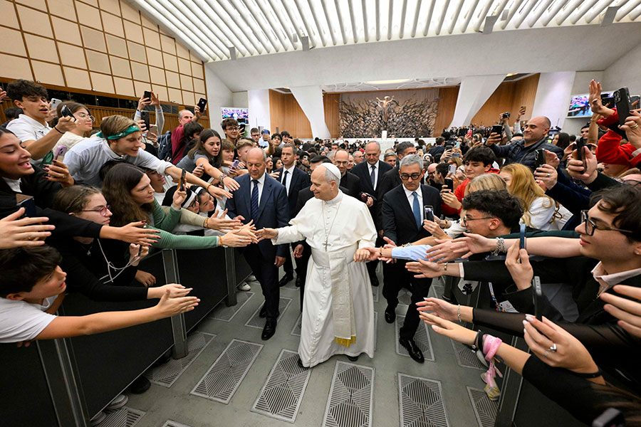 Pope Leo grasps students' hands
