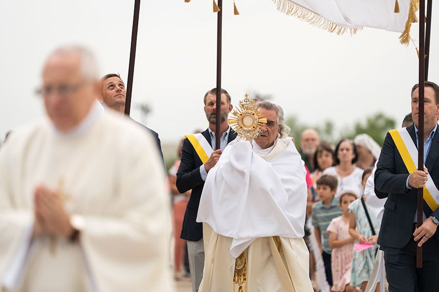 Msgr. Xuereb bears the monstrance during a Eucharistic procession