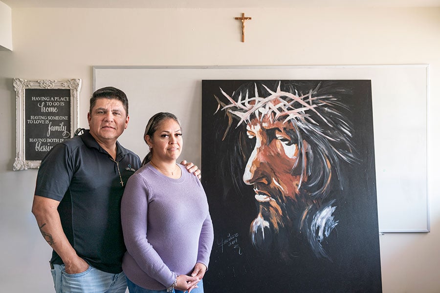 The Plasencia couple before a portrait of Jesus