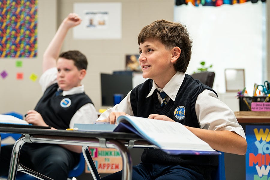 Students at Holy Family Catholic School smile and participate in a Q&A with Bishop Michael Olson. (NTC/Juan Guajardo)