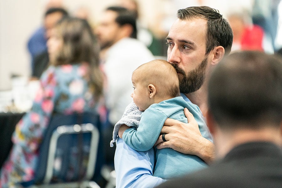 Brad Endres, a parishioner of Sacred Heart Church in Muenster and Light of Christ recipient, holds his baby during the Light of Christ Parish Stewardship Awards on June 24, 2023 at Holy Family Church.
