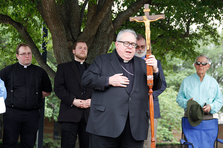 Bishop Olson prays with Deacons Blake Thompson and Isaac McCraken behind him