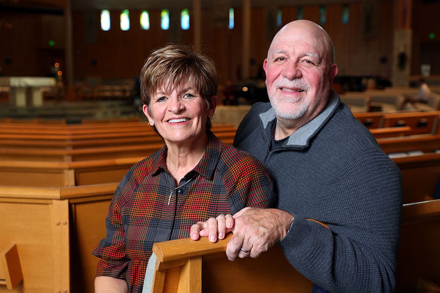 Teresa and husband David pose together in a church