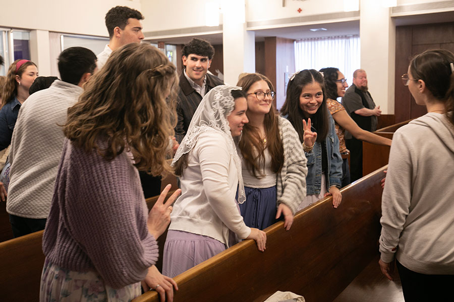 College students share the sign of the peace during the second annual Purple Mass for TCU students and alumni at Holy Family Catholic Church, Saturday, March 7, 2026. (NTC/Rodger Mallison)