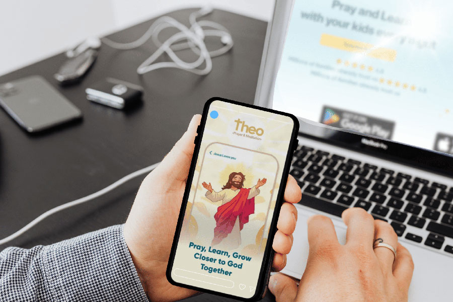 Person holds phone with Theo App and types on computer for Theo website