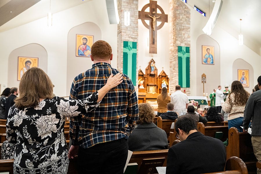 A sponsor places her hand on the shoulder of one of the Elect during the Rite of Election on Feb. 11, 2024, at Our Lady Queen of Peace Parish in Wichita Falls. Catechumens and candidates from parishes throughout the Northwest Deanery attended the liturgy. (NTC/Juan Guajardo)