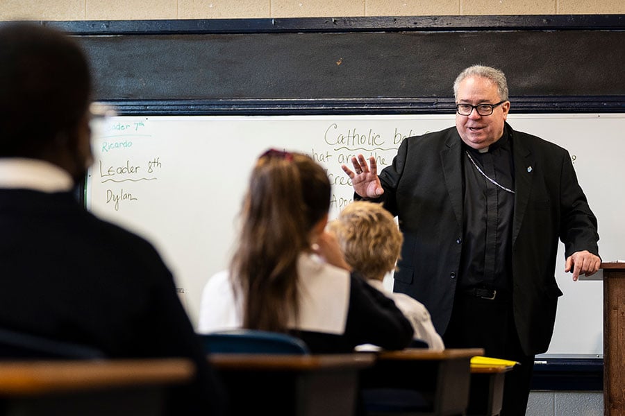 Bishop Olson speaks to students in a classroom