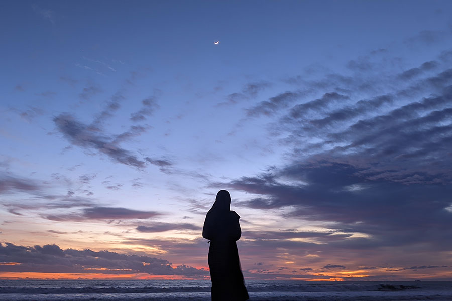 A nun looks into the sunset