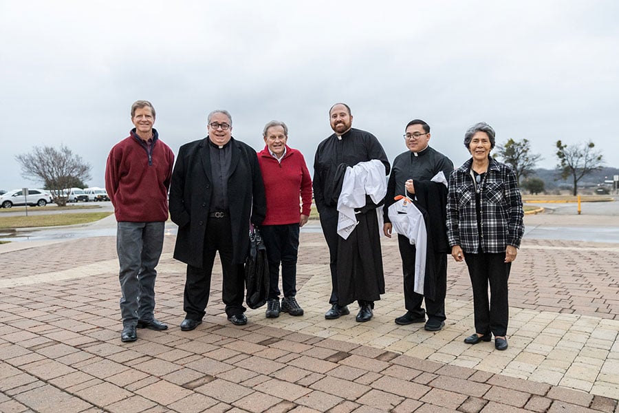 Bishop Olson with two seminarians and three lay volunteers