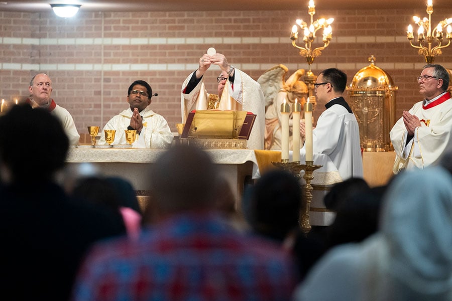 Bishop Olson elevates the Eucharist