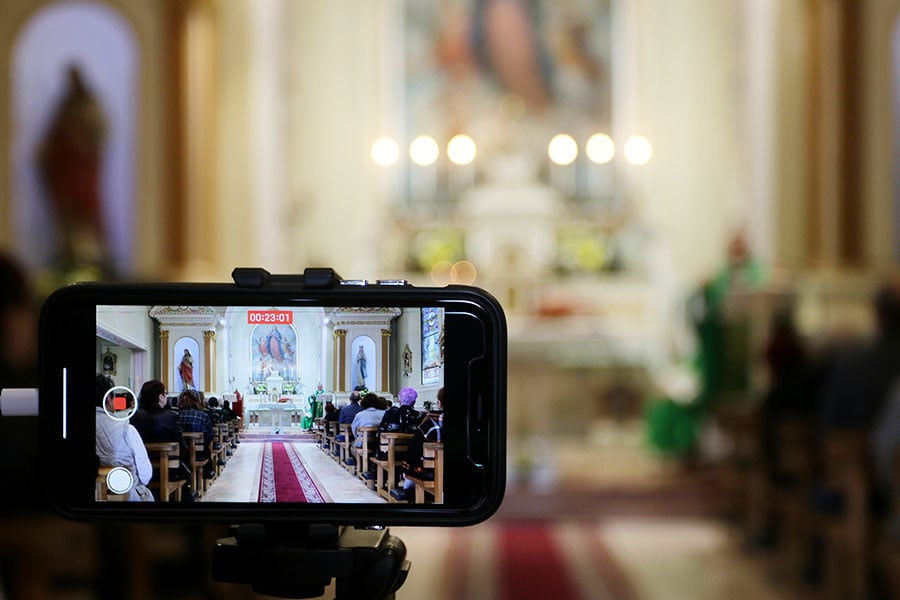 a phone broadcasts Mass live